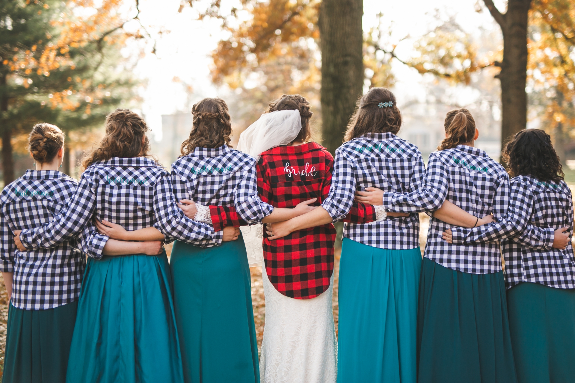 bride with bridesmaids wearing matching or coordinating shirts for a group photo by boise Idaho wedding photographer Miranda Renee