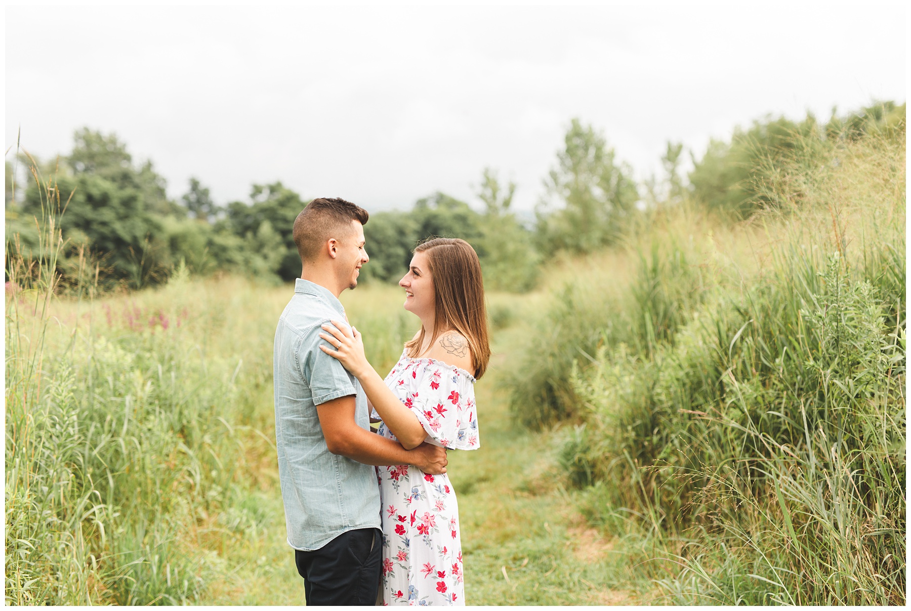 Couple embraces during engagement session at Long Dock Park in Beacon NY