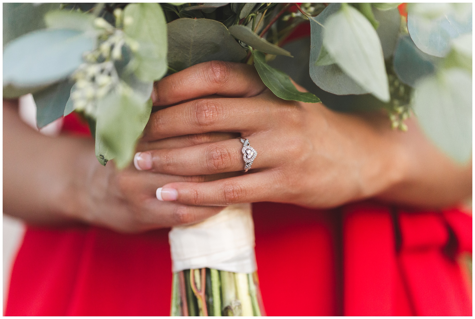 bride holding bouquet with heart-shaped ring