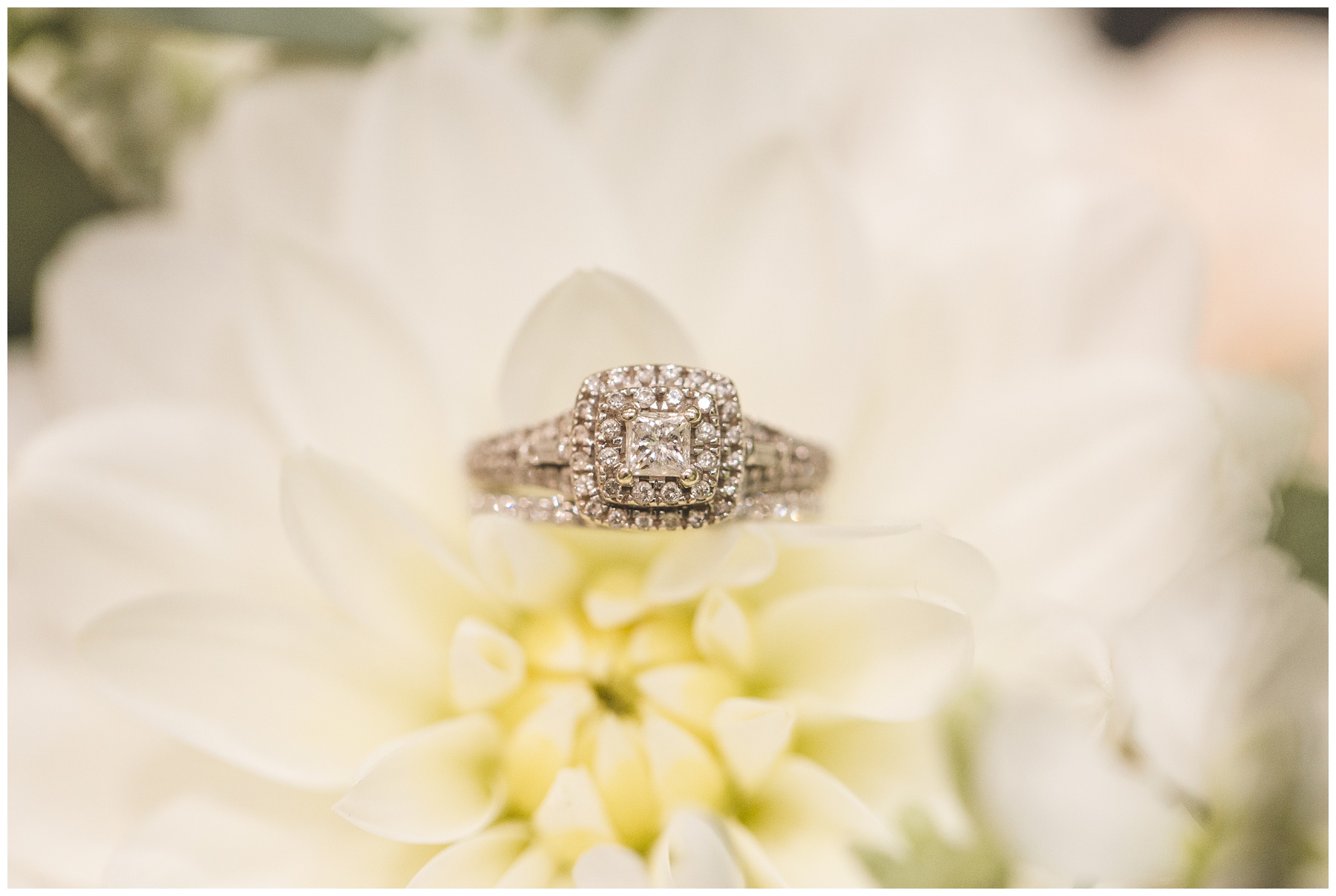 Cloudy wedding day wedding ring in flowers photographed by Miranda Renee Photography