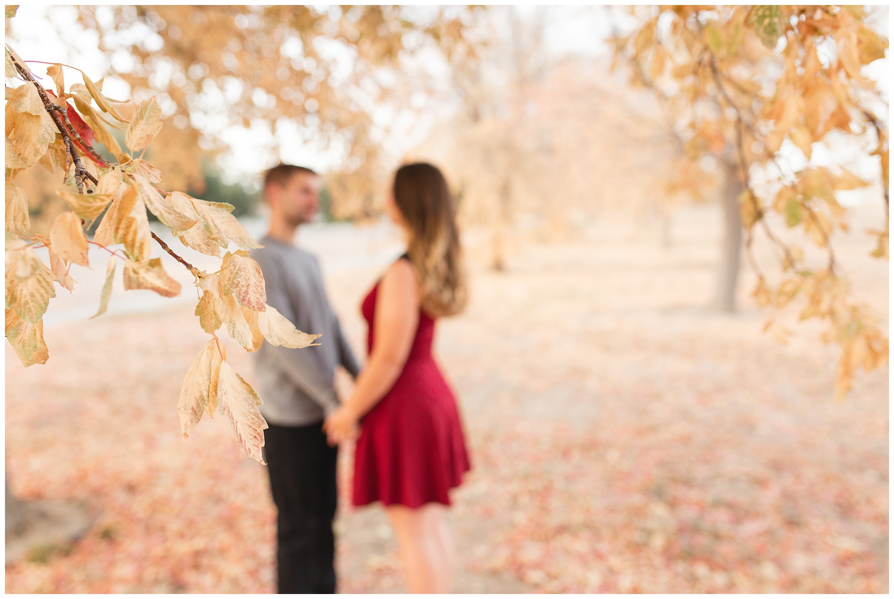 Natural light couples session standing under tree in the fall