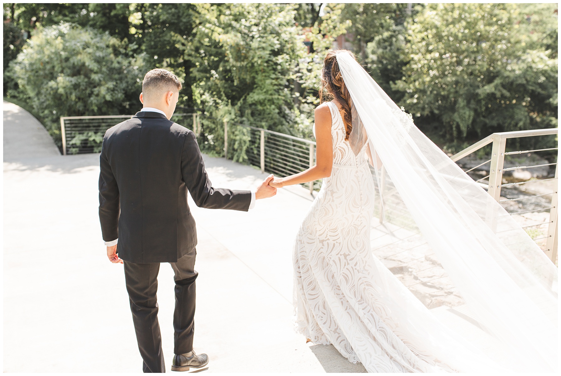 candid photography of couple walking away from camera gold and cream wedding