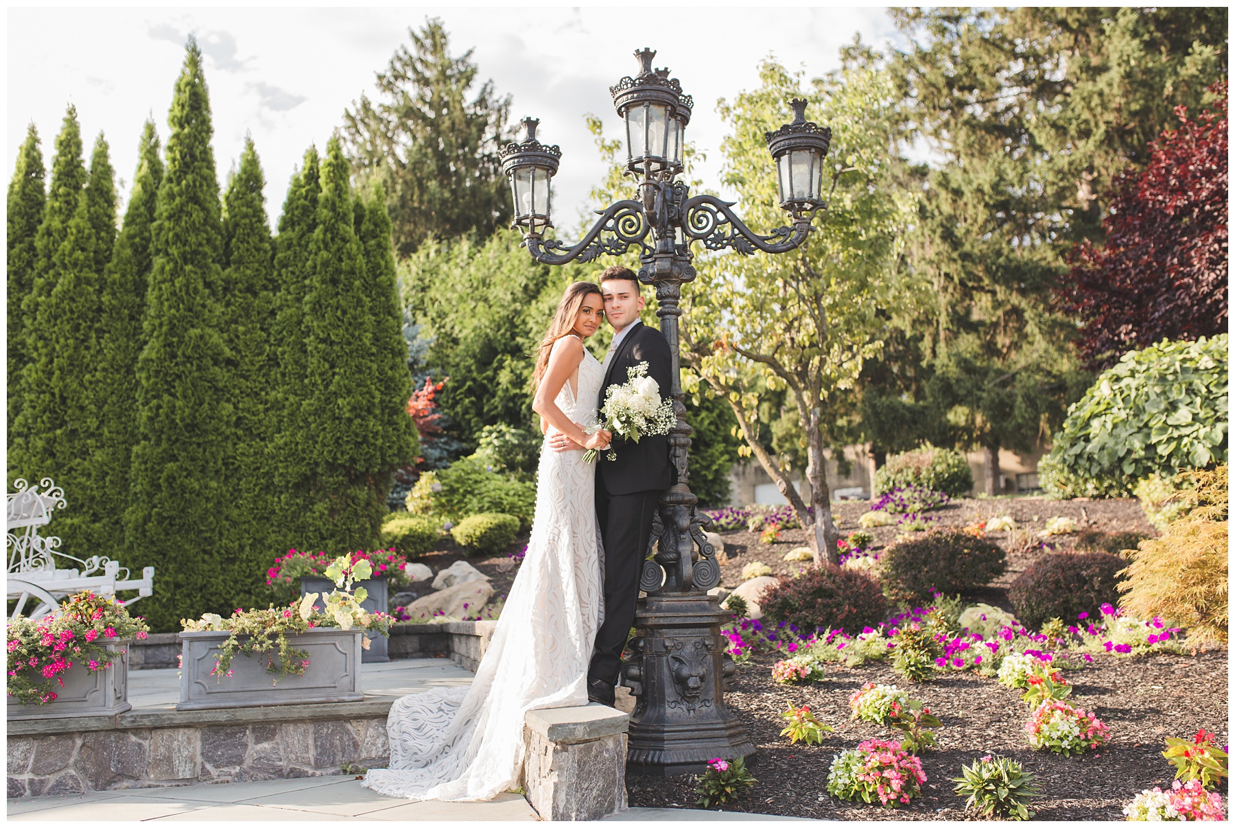 newlyweds posing in garden for Miranda Renee Photography gold and cream wedding. high-end luxury wedding