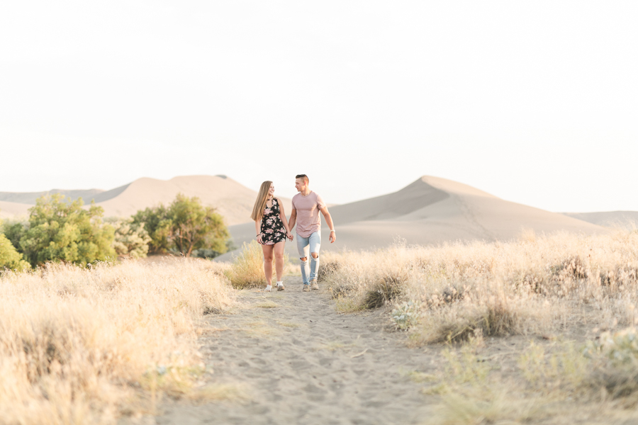 Couple walking toward camera on the bruneau sand dunes