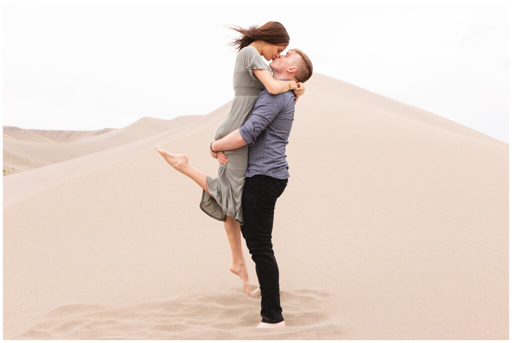 kissing on the sand dunes natural light photographer 