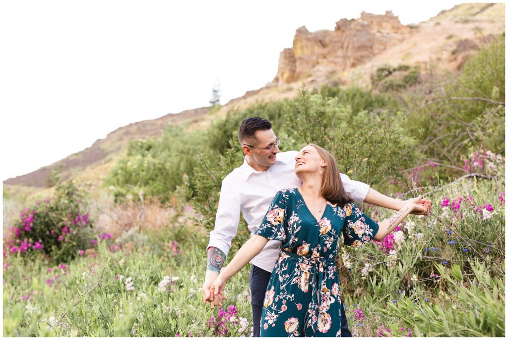 couple in wild flowers during their Sunset photo session in Mountain Home Idaho