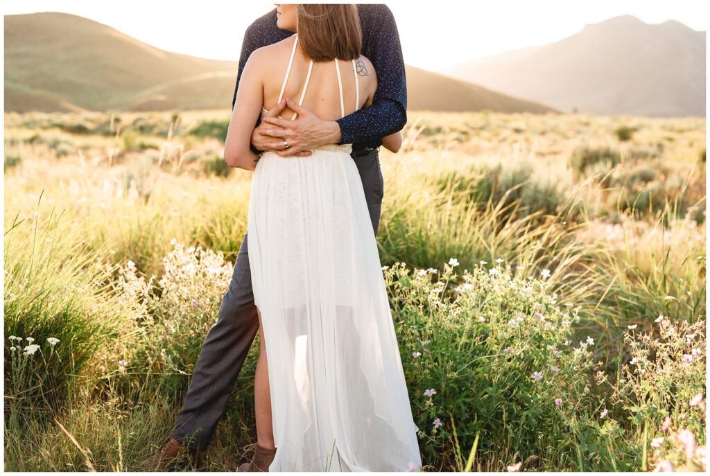 bride with back to camera in tall grass in the boise foothills.
sunset elopement