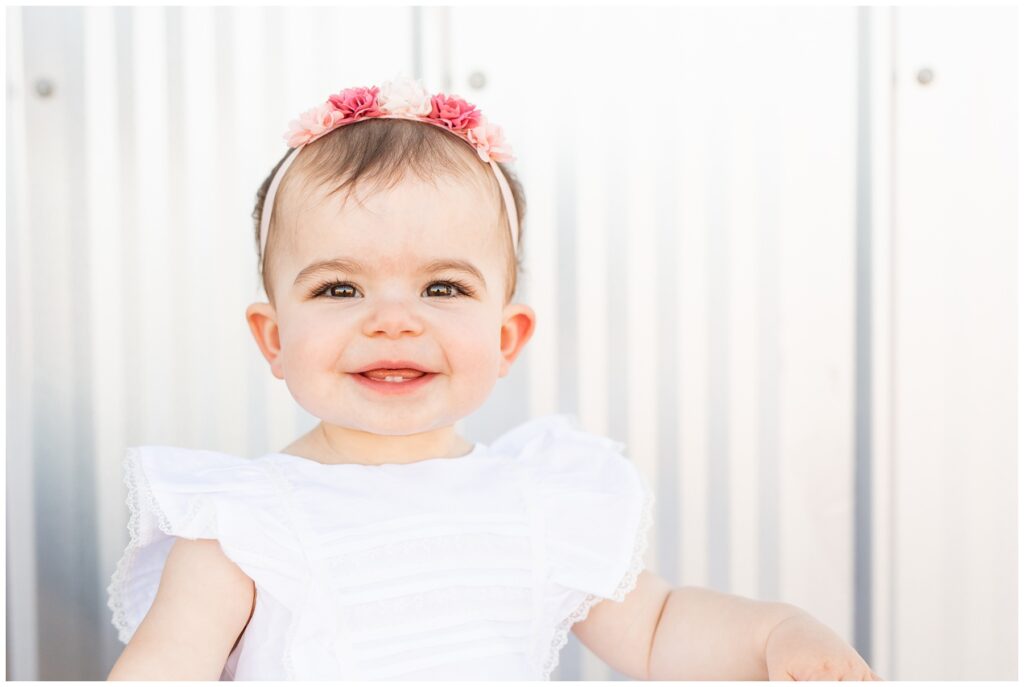 one year old smiling and looking at the camera in Idaho photo by Miranda Renee Photography