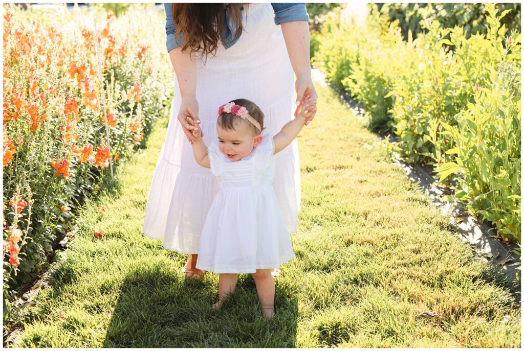mom and daughter walking toward camera at a flower farm in Boise Idaho Miranda Renee Photography