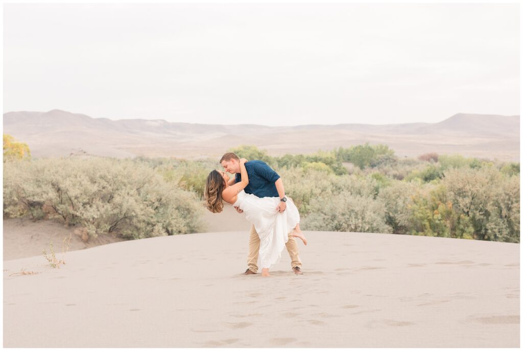 Couple dipping. Miranda Renee Photography Nampa Idaho. Sand Dunes engagement session