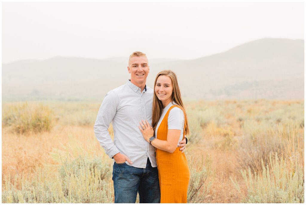 couple standing in front of mountains in Idaho photo by Miranda Renee Photography
