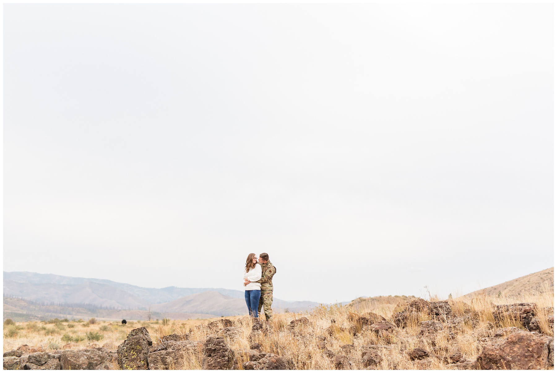 couple hugging on the edge of a cliff in boise Idaho. Photo by Miranda Renee Photography