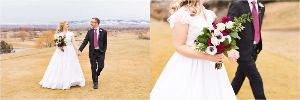 Bride and groom holding hands and walking toward the camera with mountains behind them for their January elopement in Idaho