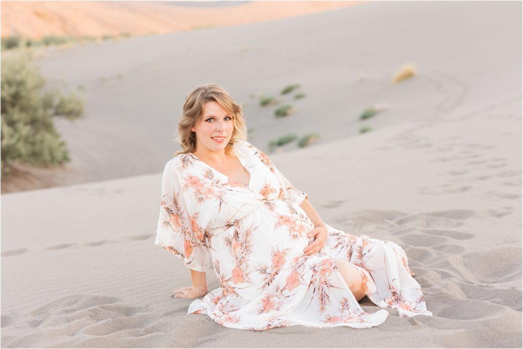 pregnant mom sitting in the sand
