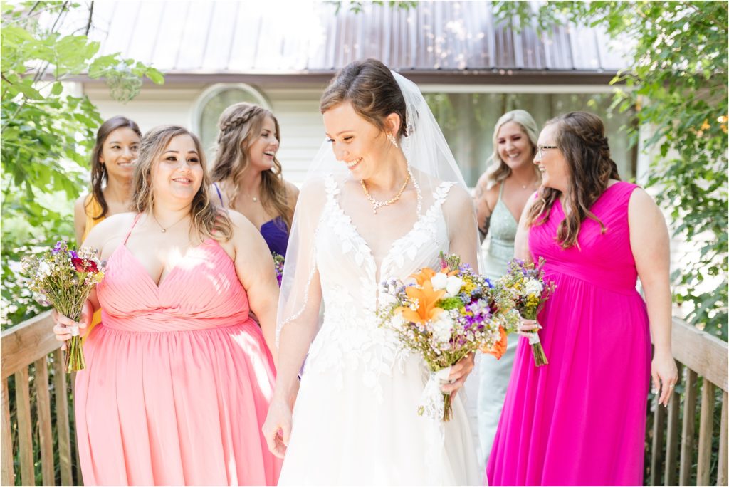 bridesmaids in multicolored dresses