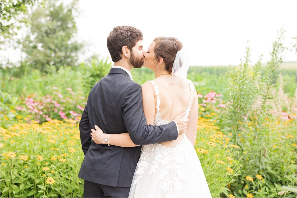 couple kissing in wildflowers