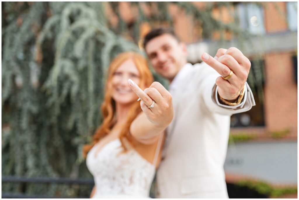 bride and groom flipping off camera in downtown Boise