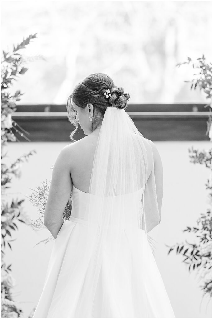 black and white photo of the back of the bride's gown and hair