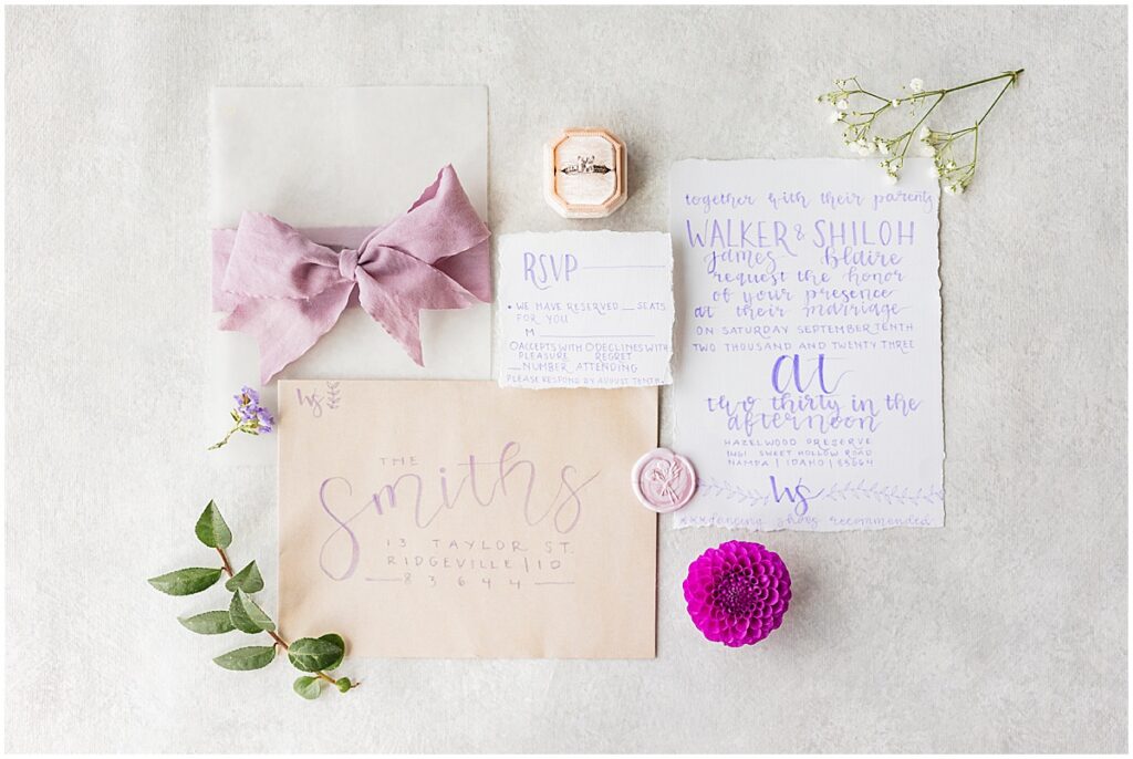 invitation suite flatlay with hand drawn calligraphy 