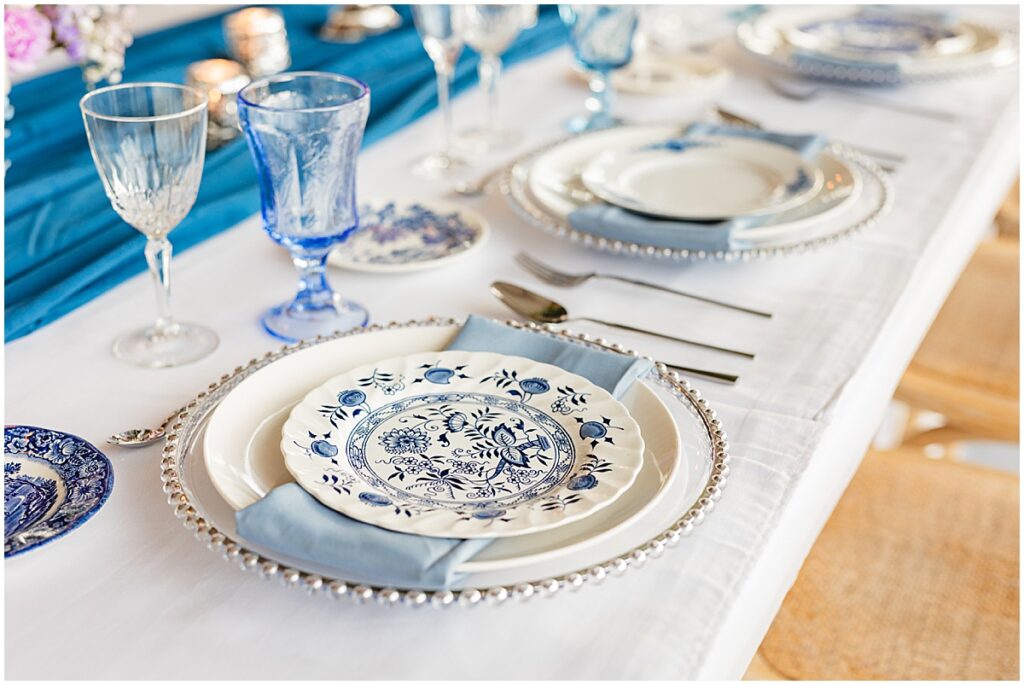 blue and ivory table setting for wedding reception