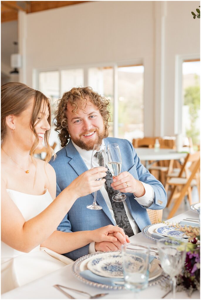 bride and groom toasting at reception