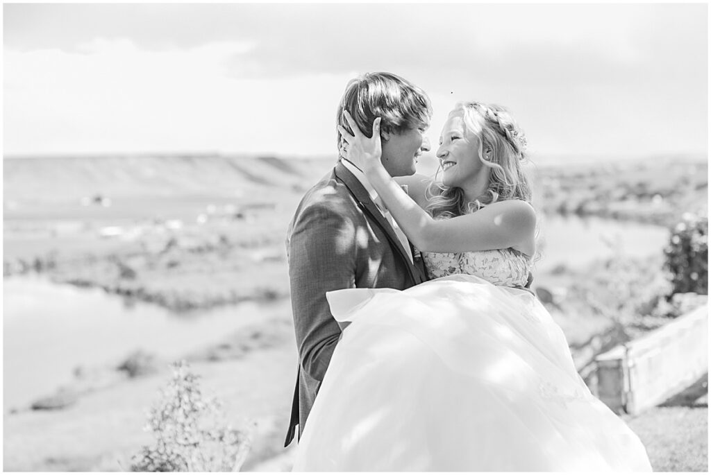 groom holding bride for pictures