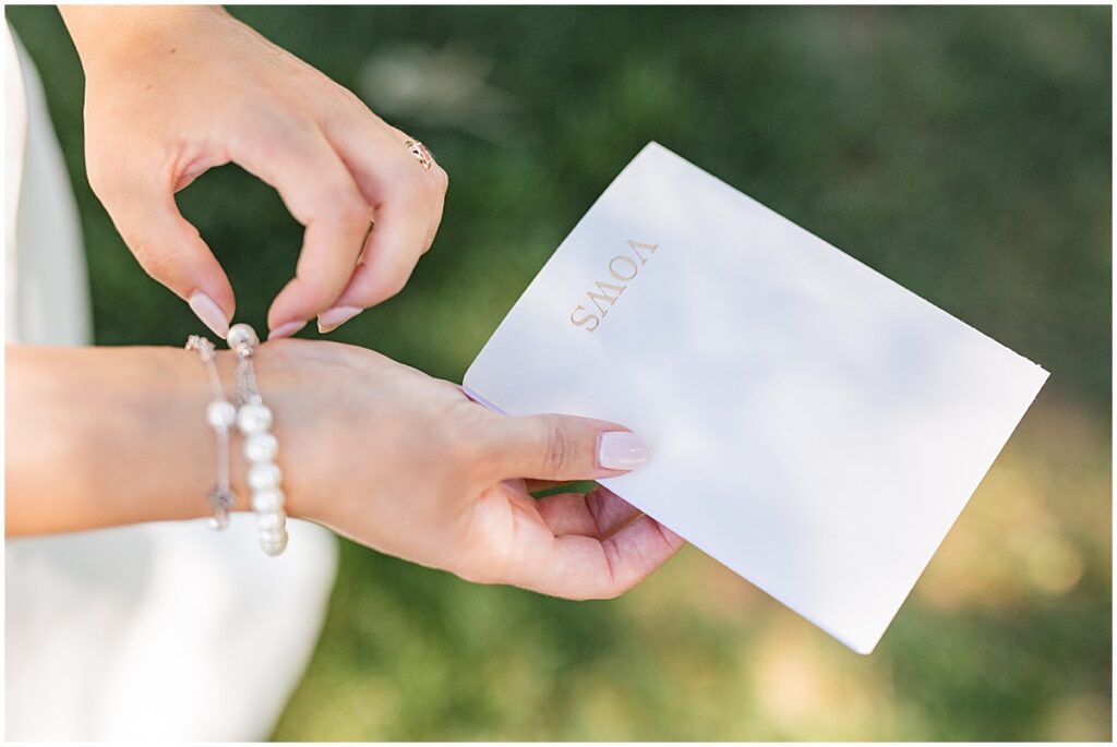 bride holding her vow book