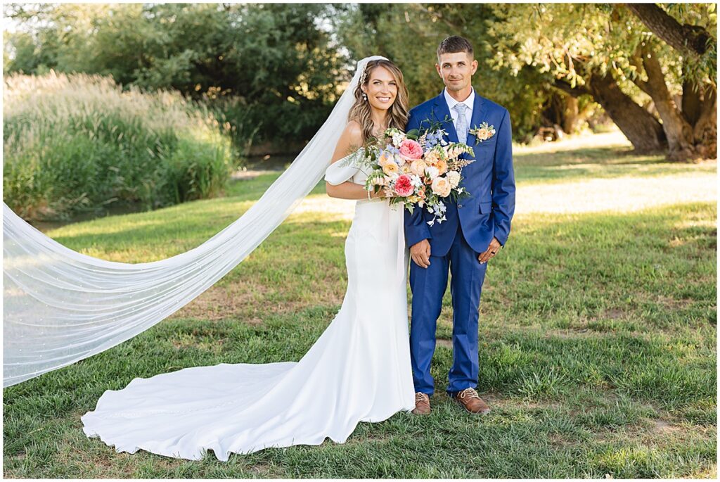 bride and groom looking at camera photo by Miranda renee photography